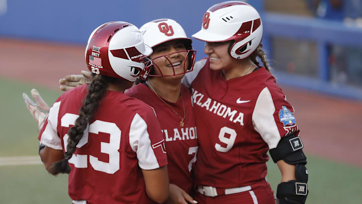 Oklahoma's Jocelyn Alo celebrates with Kinzie Hansen and Tiare Jennings at the Women's College World Series.