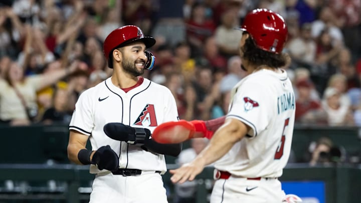 May 27, 2025; Phoenix, Arizona, USA; Arizona Diamondbacks base runner Jordan Lawlar (left) celebrates with Alek Thomas after scoring against the Pittsburgh Pirates in the fourth inning at Chase Field. Mandatory Credit: Mark J. Rebilas-Imagn Images