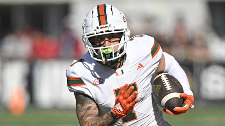 Oct 19, 2024; Louisville, Kentucky, USA;   Miami Hurricanes wide receiver Xavier Restrepo (7) runs the ball against the Louisville Cardinals during the first half at L&N Federal Credit Union Stadium. Miami defeated Louisville 52-45. Mandatory Credit: Jamie Rhodes-Imagn Images