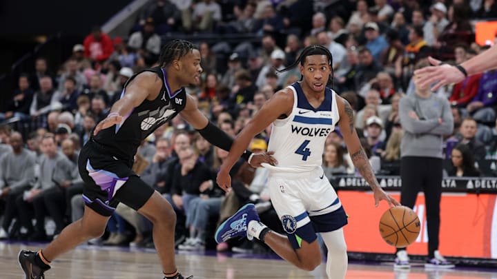 Jan 30, 2025; Salt Lake City, Utah, USA; Minnesota Timberwolves guard Rob Dillingham (4) runs past Utah Jazz guard Isaiah Collier (13) during the second half at Delta Center. Mandatory Credit: Chris Nicoll-Imagn Images