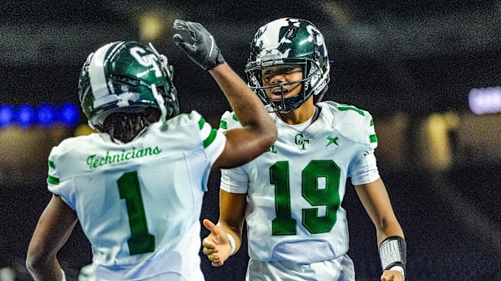 Detroit Cass Tech QB Donald Tabron II (19) celebrates Corey Sadler Jr.’s (1) touchdown against Hudsonville in the second quarter during the MHSAA Division 1 football finals at Ford Field in Detroit on Saturday, Nov. 30, 2024.