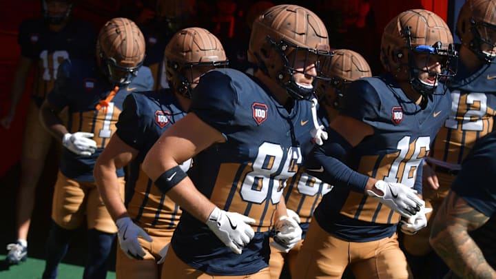 Oct 19, 2024; Champaign, Illinois, USA;  Illinois Fighting Illini players wear the throwback helmets and uniforms in honor of legendary Red Grange and the 100th anniversary of Memorial Stadium before the game against the Michigan Wolverines. Mandatory Credit: Ron Johnson-Imagn Images