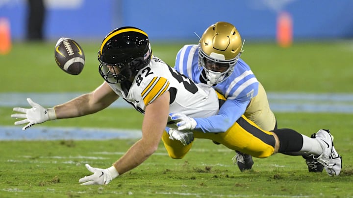 Nov 8, 2024; Pasadena, California, USA;   UCLA Bruins defensive back K.J. Wallace (7) defends Iowa Hawkeyes tight end Johnny Pascuzzi (82) forcing an incomplete pass in the first half at the Rose Bowl. Mandatory Credit: Jayne Kamin-Oncea-Imagn Images