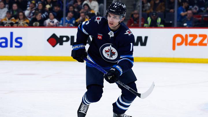 Dec 10, 2024; Winnipeg, Manitoba, CAN;  Winnipeg Jets defenseman Ville Heinola (14) awaits the face-off against the Boston Bruins during the first period at Canada Life Centre. Mandatory Credit: Terrence Lee-Imagn Images