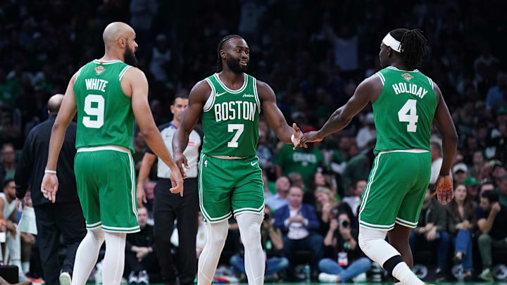Oct 22, 2024; Boston, Massachusetts, USA; Boston Celtics guard Jaylen Brown (7), guard Jrue Holiday (4) and guard Derrick White (9) react after a play against the New York Knicks in the second half at TD Garden. Mandatory Credit: David Butler II-Imagn Images