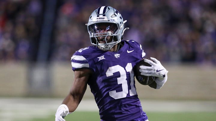 Nov 23, 2024; Manhattan, Kansas, USA; Kansas State Wildcats running back DJ Giddens (31) carries the ball during the fourth quarter against the Cincinnati Bearcats at Bill Snyder Family Football Stadium. Mandatory Credit: Scott Sewell-Imagn Images