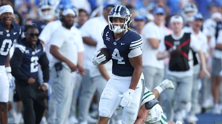 Aug 30, 2025; Provo, Utah, USA; Brigham Young Cougars running back LJ Martin (4) runs the ball against Portland State Vikings linebacker Lonnie Burt (40) during the second quarter at LaVell Edwards Stadium. Mandatory Credit: Rob Gray-Imagn Images