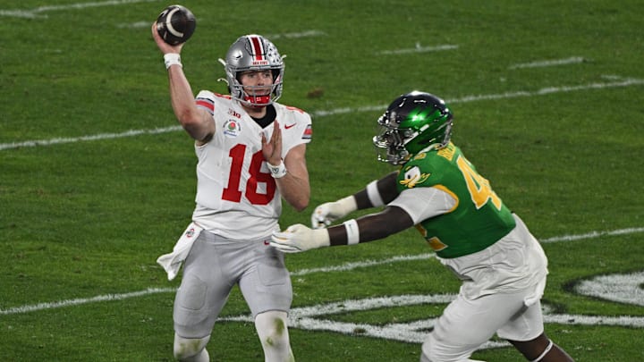 Jan 1, 2025; Pasadena, CA, USA; Ohio State Buckeyes quarterback Will Howard (18) passes against Oregon Ducks defensive lineman Aydin Breland (42) in during the fourth quarter at Rose Bowl Stadium. Mandatory Credit: Robert Hanashiro-Imagn Images