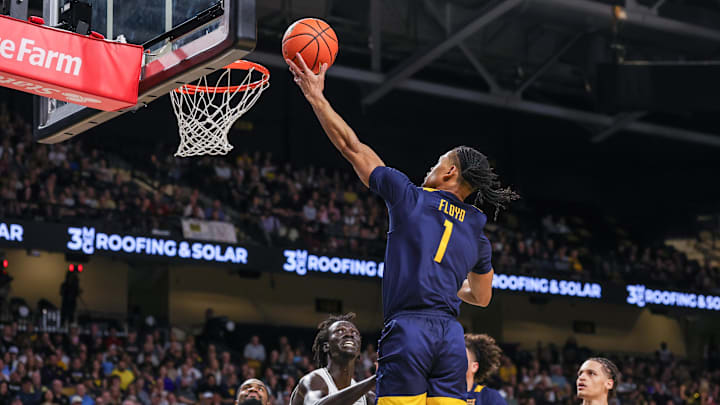 Feb 14, 2026; Orlando, Florida, USA; West Virginia Mountaineers guard Jasper Floyd (1) goes to the basket against UCF Knights center John Bol (7) during the first half at Addition Financial Arena. Mandatory Credit: Mike Watters-Imagn Images Feb 14, 2026; Orlando, Florida, USA; West Virginia Mountaineers guard Jasper Floyd (1) goes to the basket against UCF Knights center John Bol (7) during the first half at Addition Financial Arena. Mandatory Credit: Mike Watters-Imagn Images
