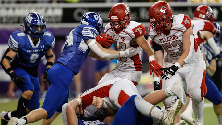 West Sioux quarterback Dylan Wiggins (10) is stopped by Van Meter linebacker John Braun (34) during the Class 1A playoff championship on Friday, Nov. 18, 2022, at the UNI-Dome in Cedar Falls. The Bulldogs are up at the half against the Falcons, 14-0.