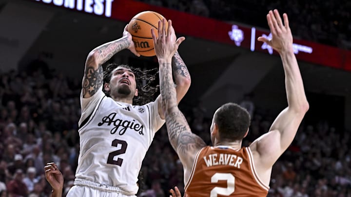 Texas A&M Aggies guard Pop Isaacs (2) shoots the ball as Texas Longhorns guard Chendall Weaver (2) defends during the second half at Reed Arena.