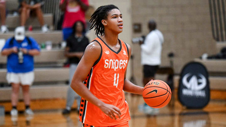 Team Snipes and Michigan State's Jordan Scott moves the ball against Team Motorcars during the Moneyball Pro-Am on Thursday, July 24, 2025, at Holt High School.