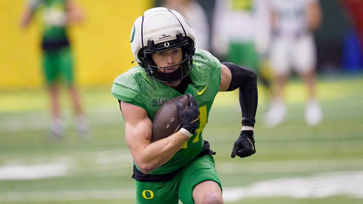 Oregon defensive back Dillon Thieneman carries the ball as the Oregon Ducks practice on Jan. 5, 2025, at the Moshofsky Center in Eugene, Oregon, ahead of the Peach Bowl.