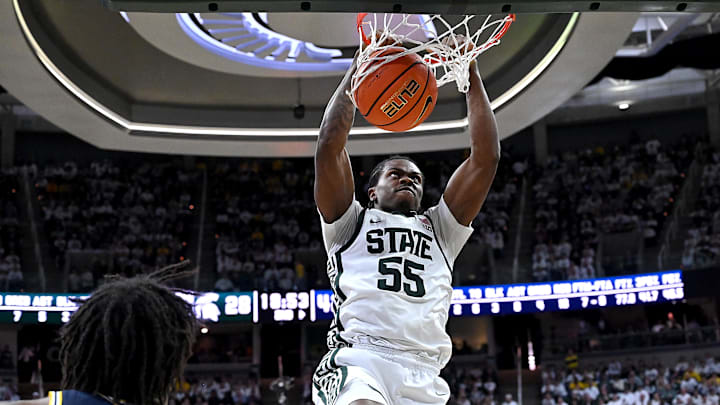 Jan 30, 2026; East Lansing, Michigan, USA; Michigan State Spartans forward Coen Carr (55) dunks against Michigan Wolverines forward Morez Johnson Jr. (21) during the second half at Jack Breslin Student Events Center. Mandatory Credit: Dale Young-Imagn Images Jan 30, 2026; East Lansing, Michigan, USA; Michigan State Spartans forward Coen Carr (55) dunks against Michigan Wolverines forward Morez Johnson Jr. (21) during the second half at Jack Breslin Student Events Center. Mandatory Credit: Dale Young-Imagn Images