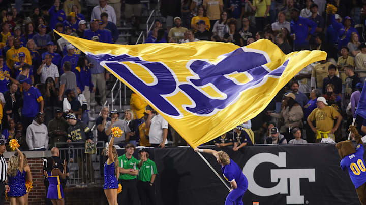 Nov 22, 2025; Atlanta, Georgia, USA; Pittsburgh Panthers cheerleader waves a flag after a touchdown against the Georgia Tech Yellow Jackets in the fourth quarter at Bobby Dodd Stadium at Hyundai Field. Mandatory Credit: Brett Davis-Imagn Images Nov 22, 2025; Atlanta, Georgia, USA; Pittsburgh Panthers cheerleader waves a flag after a touchdown against the Georgia Tech Yellow Jackets in the fourth quarter at Bobby Dodd Stadium at Hyundai Field. Mandatory Credit: Brett Davis-Imagn Images
