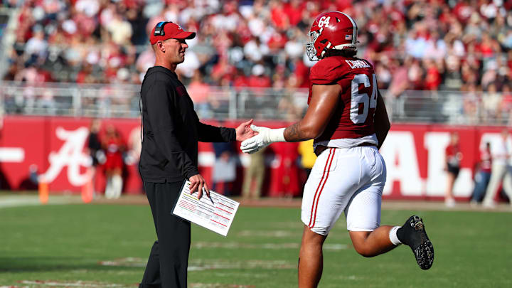 Nov 22, 2025; Tuscaloosa, Alabama, USA; Alabama Crimson Tide head coach Kalen DeBoer high fives Alabama Crimson Tide offensive lineman Michael Carroll (64) during the first half against the Eastern Illinois Panthers at Saban Field at Bryant-Denny Stadium.