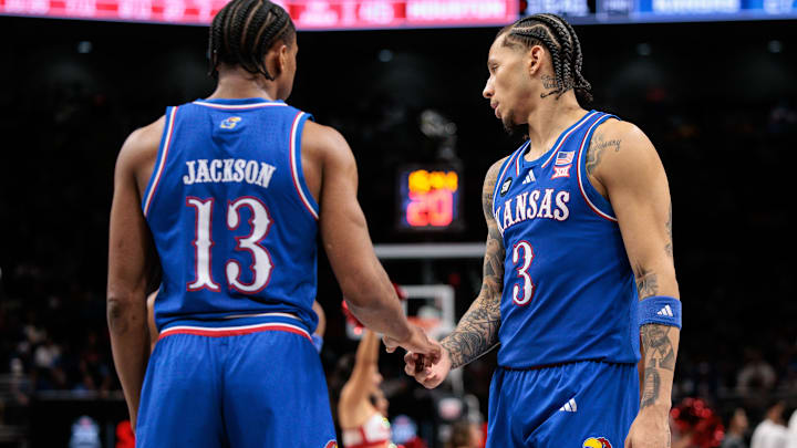 Mar 13, 2026; Kansas City, MO, USA; Kansas Jayhawks guard Elmarko Jackson (13) and Kansas Jayhawks guard Tre White (3) shake hands during the second half against the Houston Cougars at T-Mobile Center. Mandatory Credit: William Purnell-Imagn Images Mar 13, 2026; Kansas City, MO, USA; Kansas Jayhawks guard Elmarko Jackson (13) and Kansas Jayhawks guard Tre White (3) shake hands during the second half against the Houston Cougars at T-Mobile Center. Mandatory Credit: William Purnell-Imagn Images