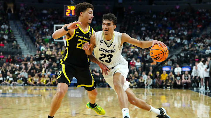 Mar 16, 2024; Las Vegas, NV, USA; Colorado Buffaloes forward Tristan da Silva (23) dribbles against Oregon Ducks guard Jadrian Tracey (22) during the first half at T-Mobile Arena.