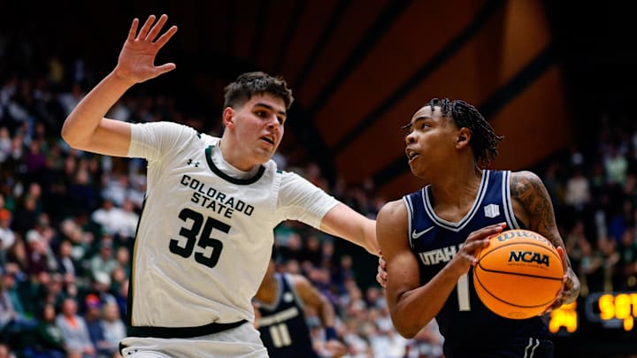 Utah State guard Elijah Perryman drives with the ball against Colorado State forward Kyle Jorgensen.