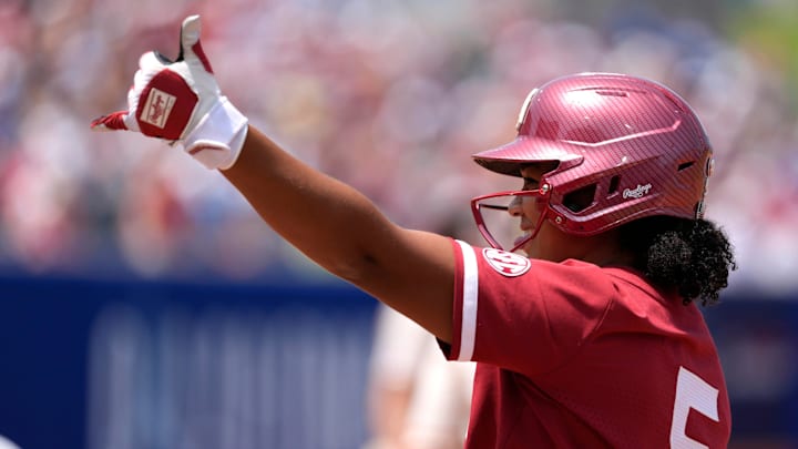 Oklahoma slugger Ella Parker celebrates after reaching base in the WCWS.