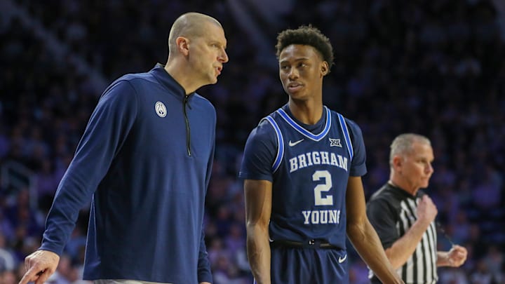 Feb 24, 2024; Manhattan, Kansas, USA; Brigham Young Cougars head coach Mark Pope talks to guard Jaxson Robinson (2) during a break in first-half action against the Kansas State Wildcats at Bramlage Coliseum. Mandatory Credit: Scott Sewell-Imagn Images