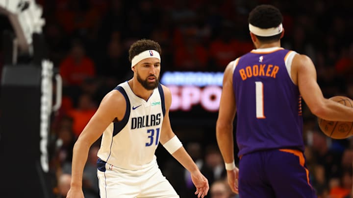 Oct 26, 2024; Phoenix, Arizona, USA; Dallas Mavericks guard Klay Thompson (31) against Phoenix Suns guard Devin Booker (1) at Footprint Center. Mandatory Credit: Mark J. Rebilas-Imagn Images