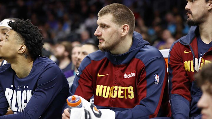 Feb 1, 2025; Charlotte, North Carolina, USA; Denver Nuggets center Nikola Jokic (15) watches from the bench during the second quarter against the Charlotte Hornets at Spectrum Center. Mandatory Credit: Brian Westerholt-Imagn Images
