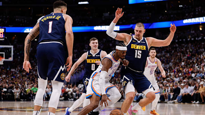 May 11, 2025; Denver, Colorado, USA; Oklahoma City Thunder guard Shai Gilgeous-Alexander (2) controls the ball against Denver Nuggets center Nikola Jokic (15) and guard Christian Braun (0) and forward Michael Porter Jr. (1) in the first quarter during game four of the second round of the 2025 NBA Playoffs at Ball Arena. Mandatory Credit: Isaiah J. Downing-Imagn Images