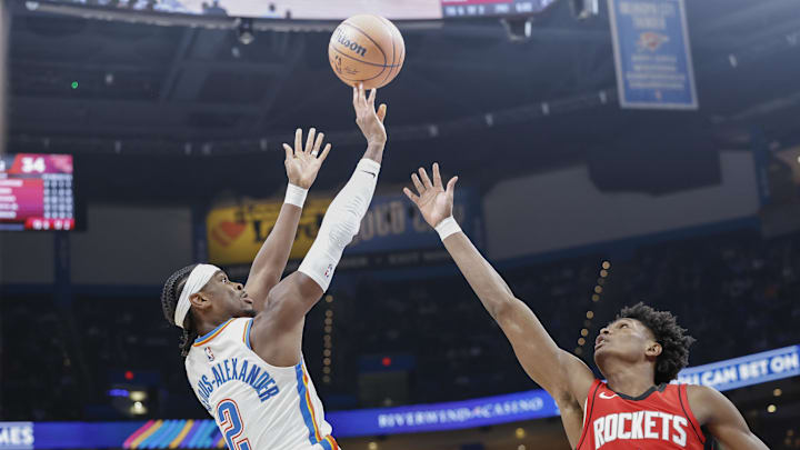 Oct 9, 2024; Oklahoma City, Oklahoma, USA; Oklahoma City Thunder guard Shai Gilgeous-Alexander (2) shoots over Houston Rockets forward Amen Thompson (1) during the second quarter at Paycom Center. Mandatory Credit: Alonzo Adams-Imagn Images