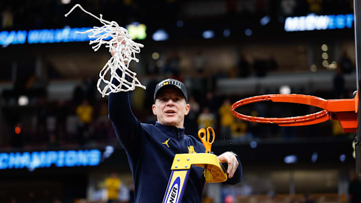 Mar 29, 2026; Chicago, IL, USA; Michigan Wolverines head coach Dusty May cuts the net after defeating Tennessee Volunteers in an Elite Eight game of the Midwest Regional of the men's 2026 NCAA Tournament at United Center. Mandatory Credit: Kamil Krzaczynski-Imagn Images
