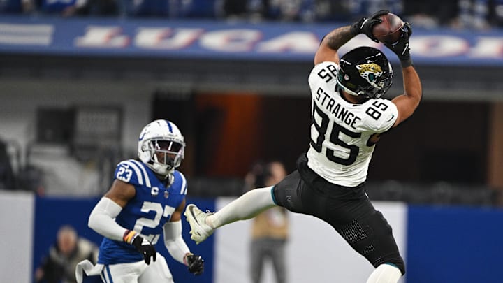 Jan 5, 2025; Indianapolis, Indiana, USA; Jacksonville Jaguars tight end Brenton Strange (85) jumps to catch a ball in front of Indianapolis Colts cornerback Kenny Moore II (23) during the second half at Lucas Oil Stadium. Mandatory Credit: Marc Lebryk-Imagn Images