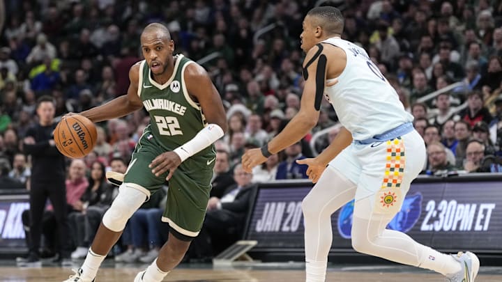 Jan 8, 2025; Milwaukee, Wisconsin, USA: Milwaukee Bucks forward Khris Middleton (22) drives for the basket against San Antonio Spurs forward Keldon Johnson (0) during the third quarter at Fiserv Forum. Mandatory Credit: Jeff Hanisch-Imagn Images