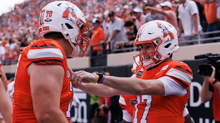 Oklahoma State Cowboys quarterback Drew Mestemaker (17) celebrates with offensive line Shaun Torgeson. Oklahoma State Cowboys quarterback Drew Mestemaker (17) celebrates with offensive line Shaun Torgeson.
