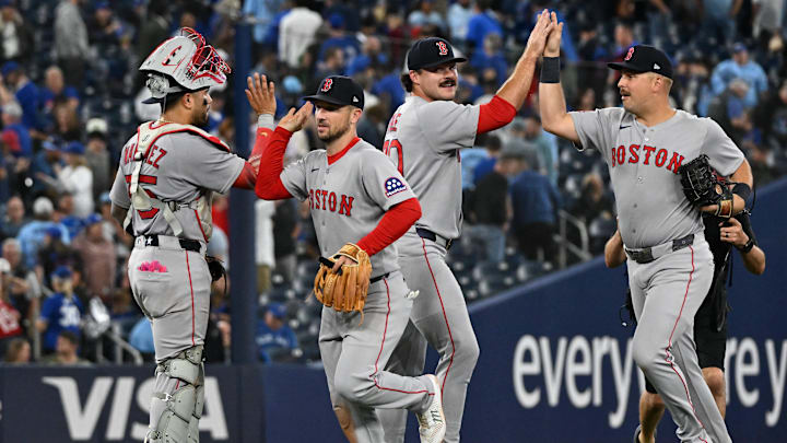 Sep 24, 2025; Toronto, Ontario, CAN; Boston Red Sox catcher Carlos Narvaez (75) celebrates with a win over the Toronto Blue Jays with third baseman Alex Bregman (2) as relief pitcher Payton Tolle (70) slaps hands with first baseman Nathaniel Lowe (37) at Rogers Centre. Mandatory Credit: Dan Hamilton-Imagn Images Sep 24, 2025; Toronto, Ontario, CAN; Boston Red Sox catcher Carlos Narvaez (75) celebrates with a win over the Toronto Blue Jays with third baseman Alex Bregman (2) as relief pitcher Payton Tolle (70) slaps hands with first baseman Nathaniel Lowe (37) at Rogers Centre. Mandatory Credit: Dan Hamilton-Imagn Images