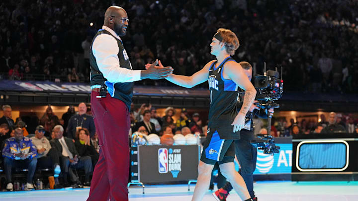 Feb 17, 2024; Indianapolis, IN, USA; Osceola Magic guard Mac McClung (0) shakes hands with former basketball player Shaquille O'Neal during the slam dunk competition during NBA All Star Saturday Night at Lucas Oil Stadium. Mandatory Credit: Kyle Terada-Imagn Images