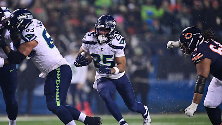 Dec 26, 2024; Chicago, Illinois, USA; Seattle Seahawks running back Kenny McIntosh (25) runs the ball against the Chicago Bears during the first quarter at Soldier Field. Mandatory Credit: Daniel Bartel-Imagn Images