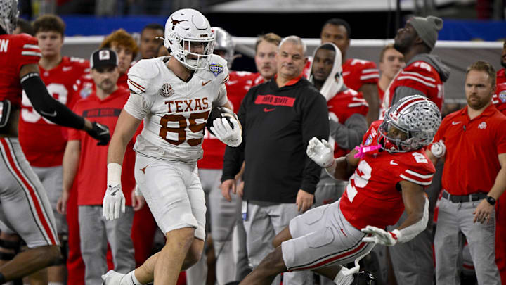 Jan 10, 2025; Arlington, TX, USA; Texas Longhorns tight end Gunnar Helm (85) shoves Ohio State Buckeyes safety Caleb Downs (2) and draws a penalty during the game between the Texas Longhorns and the Ohio State Buckeyes at AT&T Stadium. Mandatory Credit: Jerome Miron-Imagn Images