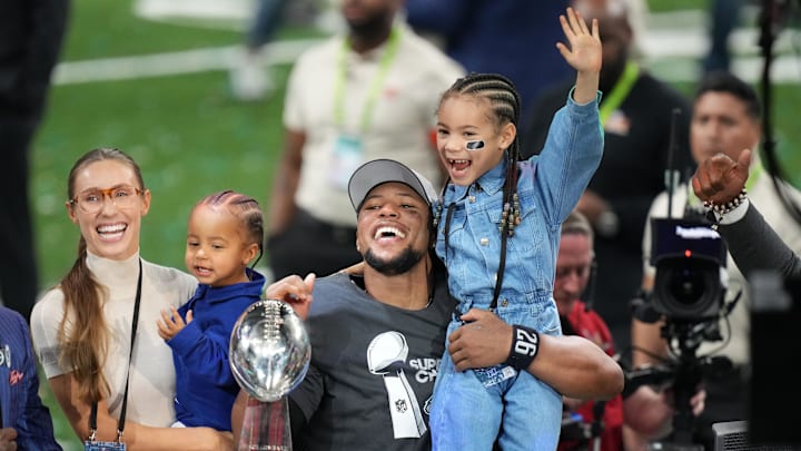 Philadelphia Eagles running back Saquon Barkley talks to the media with his daughter, Jada, after defeating the Kansas City Chiefs in Super Bowl LIX at Caesars Superdome.