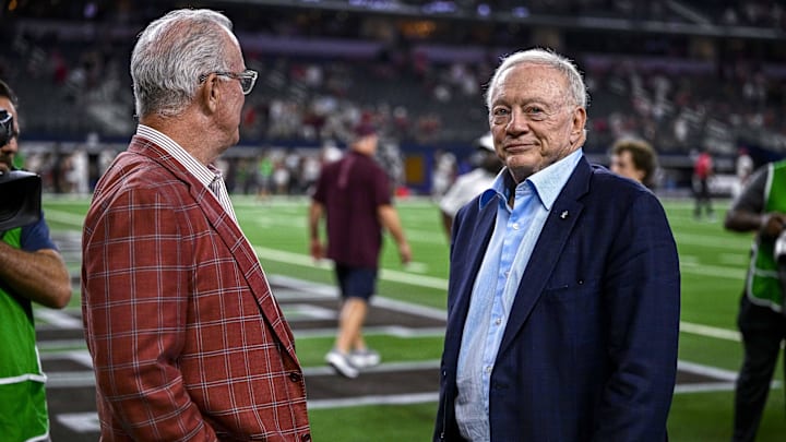 Dallas Cowboys owner Jerry Jones and son Stephen Jones wait to present the winner's trophy after the game between the Texas A&M Aggies and Arkansas Razorbacks.