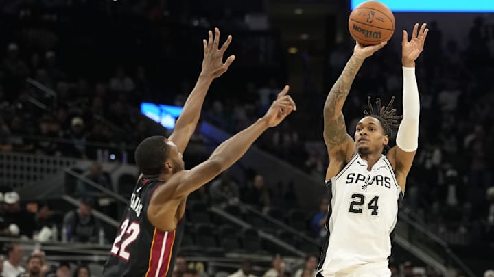 Oct 30, 2025; San Antonio, Texas, USA; San Antonio Spurs guard Devin Vassell (24) shoots over Miami Heat forward Andrew Wiggins (22) during the first half at Frost Bank Center. Mandatory Credit: Scott Wachter-Imagn Images