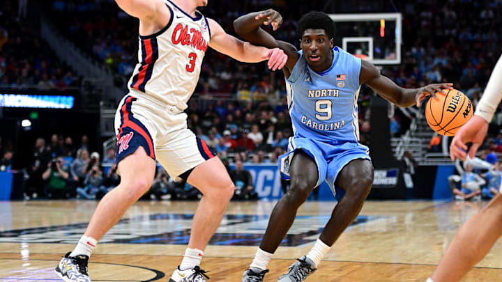 Mar 21, 2025; Milwaukee, WI, USA; North Carolina Tar Heels guard Drake Powell (9) drives against Mississippi Rebels guard Sean Pedulla (3) during the first half of a first round NCAA men’s tournament game at Fiserv Forum. Mandatory Credit: Benny Sieu-Imagn Images