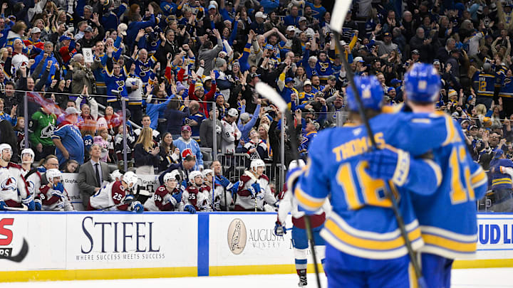 Apr 5, 2025; St. Louis, Missouri, USA;  Fans celebrate after St. Louis Blues center Robert Thomas (18) scored an empty net goal against the Colorado Avalanche at Enterprise Center. The Blues would go on to defeat the Avalanche and record a franchise record 12th straight win. Mandatory Credit: Jeff Curry-Imagn Images
