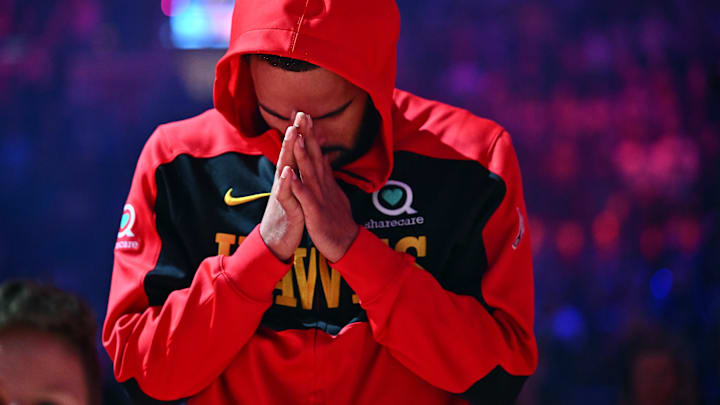 Trae Young #11 of the Atlanta Hawks prays before facing the Cleveland Cavaliers.
