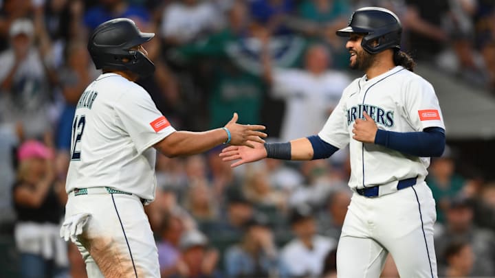 Aug 5, 2025; Seattle, Washington, USA; Seattle Mariners first baseman Josh Naylor (12) and third baseman Eugenio Suarez (28) celebrate after both scored a run against the Chicago White Sox during the sixth inning at T-Mobile Park. Mandatory Credit: Steven Bisig-Imagn Images