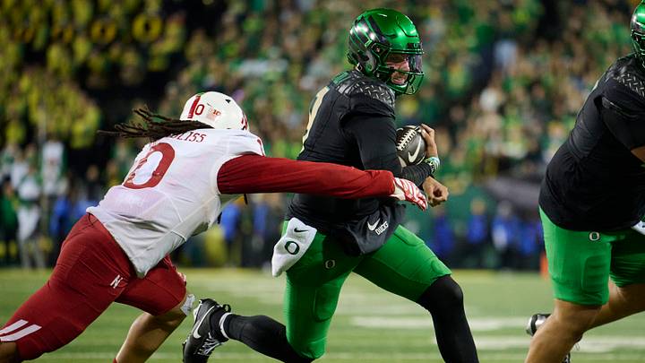 Oregon quarterback runs for yardage against his former team. Oregon quarterback runs for yardage against his former team.