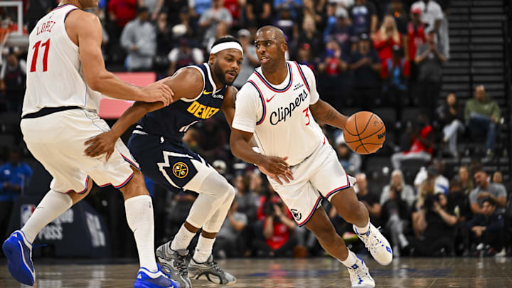 Oct 12, 2025; Inglewood, California, USA; Los Angeles Clippers guard Chris Paul (3) moves the ball with center Brook Lopez (11) against Denver Nuggets guard Bruce Brown (11) during the second quarter at Intuit Dome. Mandatory Credit: Jonathan Hui-Imagn Images