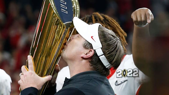 Georgia coach Kirby Smart kisses the National Championship trophy while celebrating after winning the College Football Playoff National Championship game in Indianapolis, on Monday, Jan. 10, 2022.