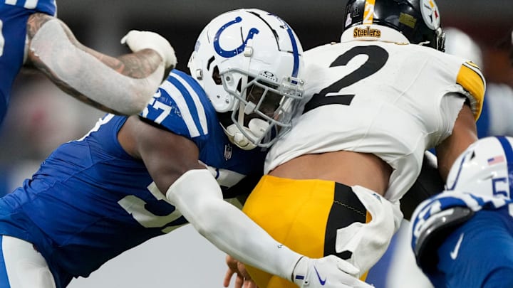 Indianapolis Colts linebacker Jaylon Carlies (57) wraps up Pittsburgh Steelers quarterback Justin Fields (2) on Sunday, Sept. 29, 2024, during a game against the Pittsburgh Steelers at Lucas Oil Stadium in Indianapolis.