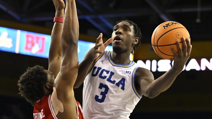 Nov 11, 2024; Los Angeles, California, USA; UCLA Bruins guard Eric Dailey Jr. (3) drives to the basket on Boston University Terriers forward Malcolm Chimezie (3) during the second half at Pauley Pavilion presented by Wescom. Mandatory Credit: Robert Hanashiro-Imagn Images