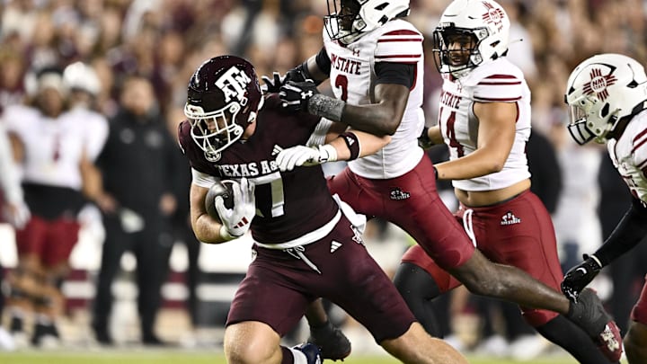 Nov 16, 2024; College Station, Texas, USA; New Mexico State Aggies safety Da'Marcus Crosby (2) tackles Texas A&M Aggies tight end Theo Melin Ohrstrom (17) during the first half at Kyle Field. Mandatory Credit: Maria Lysaker-Imagn Images 